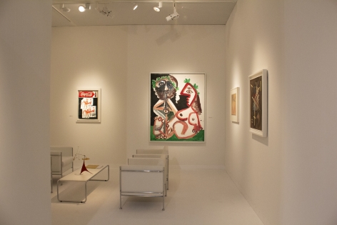 Installation view of Art Basel | Basel 2019, booth H5. ©Helly Nahmad Gallery NY. Photography by Studio MDA. This photo features the inside of the booth, we can see a painting by Picasso on the left a small painting by basquiat and on the table a small mobile by Alexander Calder.