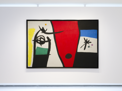 This is a photo of a large scale painting produced by Joan Miro titled "Femme à la voix de rossignol dans la nuit" and produced 1971. It is abstract and the rectangular horizontal canvas is composed of 3 ares each divided by a thick black line. The left side is depicting in a calligraphic brushstoke style executed with thick black line a shape that looks like the top part of a large fish, revealing a head and an eye. Theres a rectangular dark green area under that animal like form on the left of it is an area painting in bright yellow. On the right of that form is the center of the canvas shaped as a wide red cone shape with a large black dot at its bottom. On the right of the canvas, the area is divided in four very wide stripes piled up horizontally, the first stripe is black, the second underneath is a rich blue azure, underneath is the raw canvas not painted with the motif of a large star executed with thick black lines there is two dots on the right of it, one green, one purple. underneath there is a black stripe.