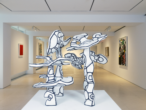 Installation view of Masterworks. This image shows sculpture by Dubuffet representing four small tree on a white pedestal in the center of the main area of the gallery. They are all painted in white and covered with thick black lines, like Dubuffet's signature Hourloupe style.